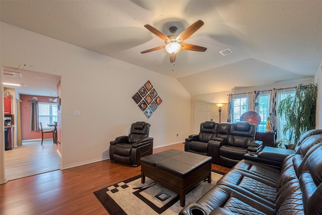 1810 Macondray Dr, Humble, TX 77396 - living room with a ceiling fan, wood finished floors, vaulted ceiling, baseboards, and a textured ceiling