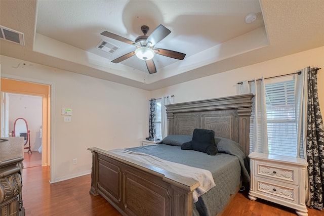 1810 Macondray Dr, Humble, TX 77396 - bedroom with a raised ceiling, wood finished floors, ceiling fan, and baseboards