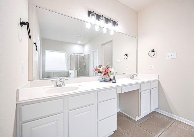 18827 Waverly Springs Ln, Cypress, TX 77429 - bathroom featuring a stall shower, double vanity, tile patterned floors, and baseboards