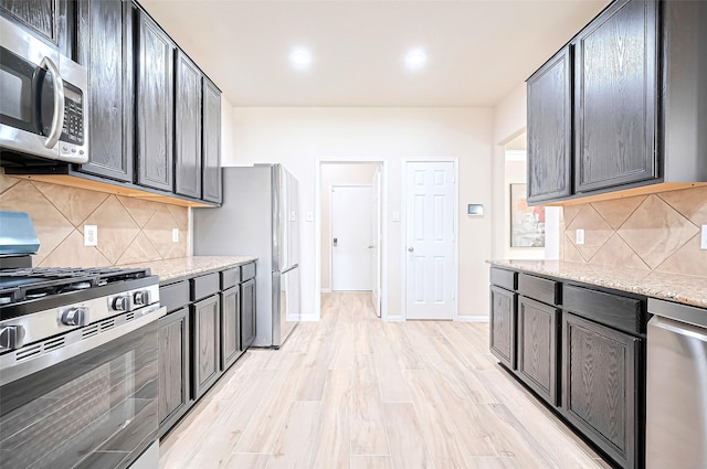 18827 Waverly Springs Ln, Cypress, TX 77429 - kitchen with stainless steel appliances, tasteful backsplash, light stone countertops, and recessed lighting