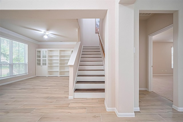 18827 Waverly Springs Ln, Cypress, TX 77429 - stairs with wood finished floors, ornamental molding, a ceiling fan, and baseboards