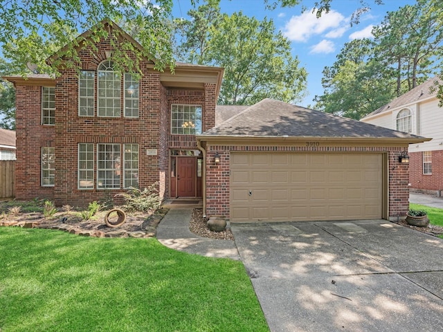 3910 Echo Mountain Dr, Kingwood, TX 77345 - traditional-style house featuring brick siding, an attached garage, driveway, a front yard, and a shingled roof