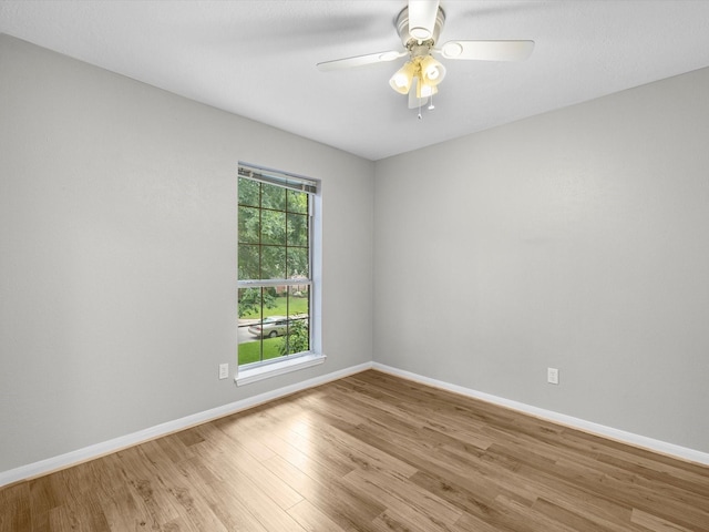 3910 Echo Mountain Dr, Kingwood, TX 77345 - spare room featuring wood finished floors, baseboards, and a ceiling fan