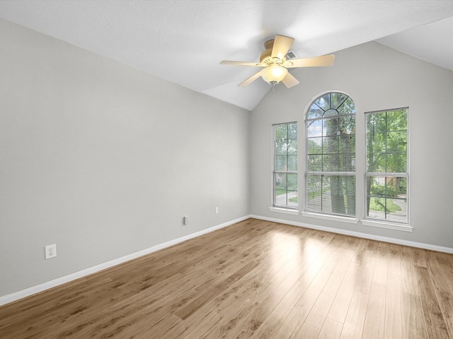 3910 Echo Mountain Dr, Kingwood, TX 77345 - unfurnished room featuring a ceiling fan, vaulted ceiling, baseboards, and wood finished floors