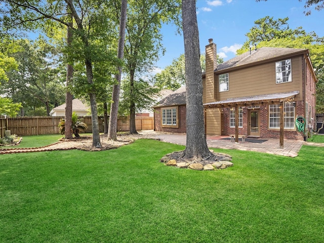3910 Echo Mountain Dr, Kingwood, TX 77345 - rear view of property with a chimney, brick siding, and a patio area