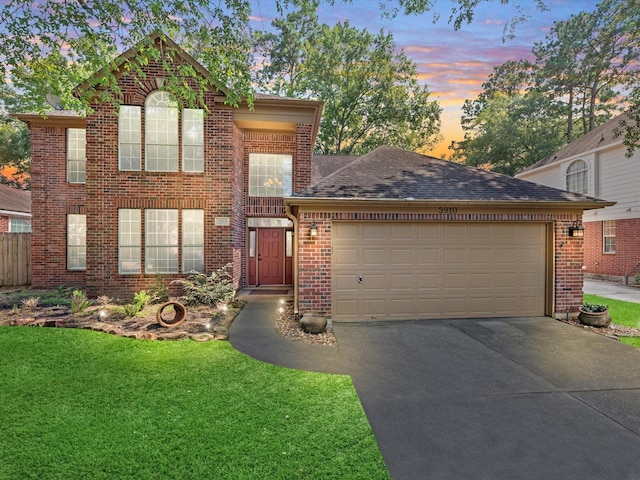 3910 Echo Mountain Dr, Kingwood, TX 77345 - traditional-style home featuring brick siding, asphalt driveway, a garage, a front yard, and a shingled roof