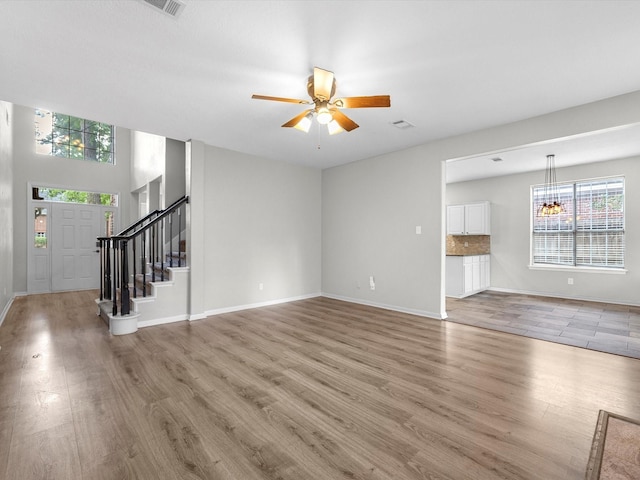 3910 Echo Mountain Dr, Kingwood, TX 77345 - unfurnished living room with plenty of natural light, light wood-type flooring, and ceiling fan