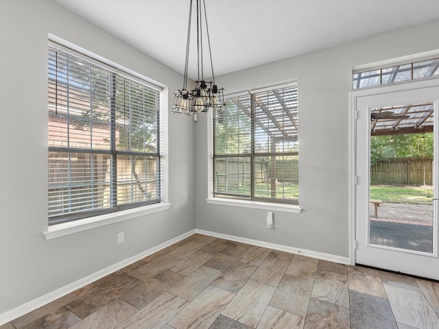 3910 Echo Mountain Dr, Kingwood, TX 77345 - unfurnished dining area with healthy amount of natural light and a chandelier
