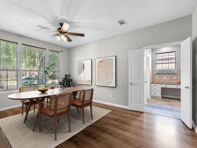 3910 Echo Mountain Dr, Kingwood, TX 77345 - dining space with a ceiling fan, baseboards, and wood finished floors