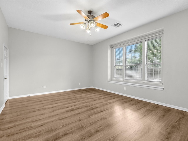 3910 Echo Mountain Dr, Kingwood, TX 77345 - unfurnished room with a ceiling fan, wood finished floors, and baseboards