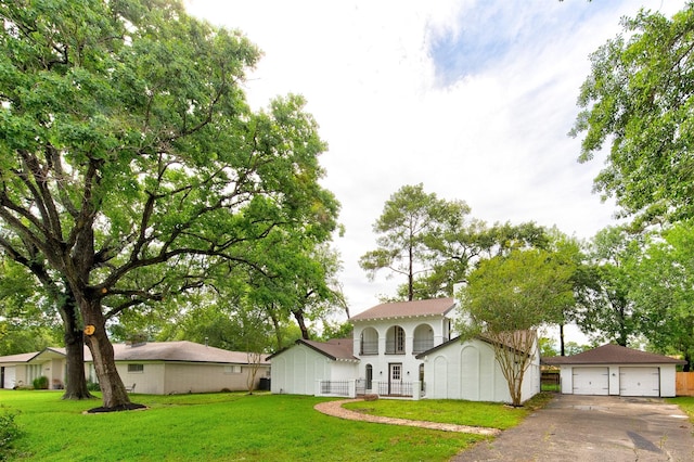 127 Red Bud Ln, Baytown, TX 77520 - view of front of home featuring an outdoor structure, a detached garage, and a front yard