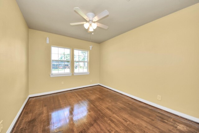 149 E Riverwood Dr, Houston, TX 77076 - unfurnished room with baseboards, dark wood-style floors, and ceiling fan