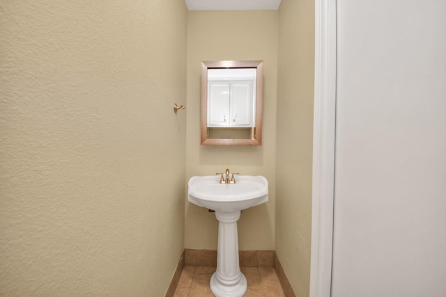 149 E Riverwood Dr, Houston, TX 77076 - bathroom with tile patterned floors, baseboards, and a sink
