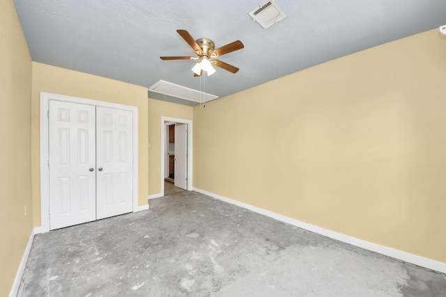 149 E Riverwood Dr, Houston, TX 77076 - unfurnished bedroom with attic access, unfinished concrete floors, baseboards, a closet, and a ceiling fan