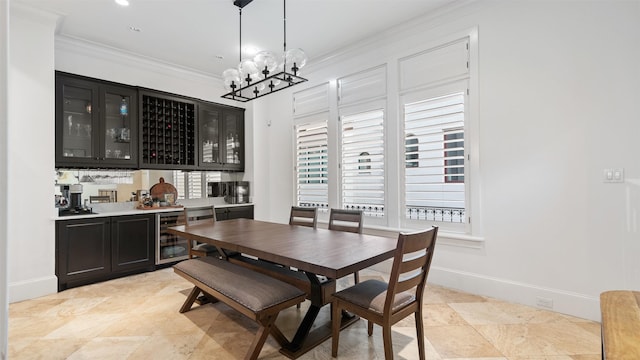 5215 Feagan St Unit A, Houston, TX 77007 - dining area featuring bar with sink, ornamental molding, a chandelier, wine cooler, and light tile patterned flooring