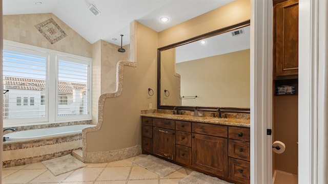 5215 Feagan St Unit A, Houston, TX 77007 - full bath featuring double vanity, a relaxing tiled tub, vaulted ceiling, baseboards, and tile patterned floors