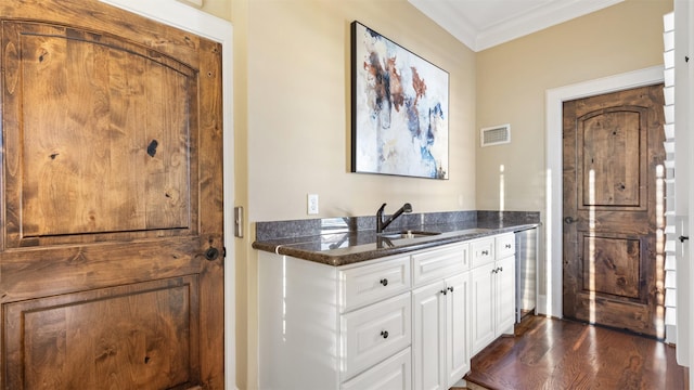 5215 Feagan St Unit A, Houston, TX 77007 - bar with a sink, ornamental molding, and dark wood-style floors