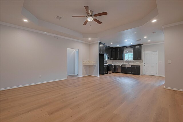 4523 Nexus Rd, Houston, TX 77053 - unfurnished living room featuring a sink, a tray ceiling, ceiling fan, light wood finished floors, and recessed lighting