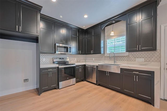 4523 Nexus Rd, Houston, TX 77053 - kitchen with stainless steel appliances, a sink, light wood-style floors, backsplash, and light countertops
