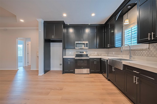 4523 Nexus Rd, Houston, TX 77053 - kitchen with appliances with stainless steel finishes, a sink, ornamental molding, healthy amount of natural light, and tasteful backsplash
