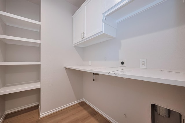 4523 Nexus Rd, Houston, TX 77053 - laundry room featuring cabinet space, electric dryer hookup, light wood finished floors, hookup for a gas dryer, and baseboards