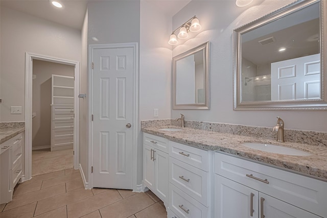 4523 Nexus Rd, Houston, TX 77053 - full bath with double vanity, tile patterned floors, and a shower