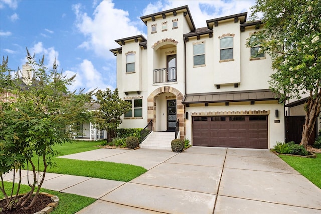 5204 Chestnut St, Bellaire, TX 77401 - view of front of home featuring a balcony, stucco siding, a garage, and driveway