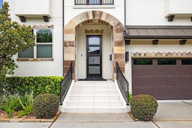 5204 Chestnut St, Bellaire, TX 77401 - entrance to property with a garage, stone siding, a standing seam roof, and stucco siding