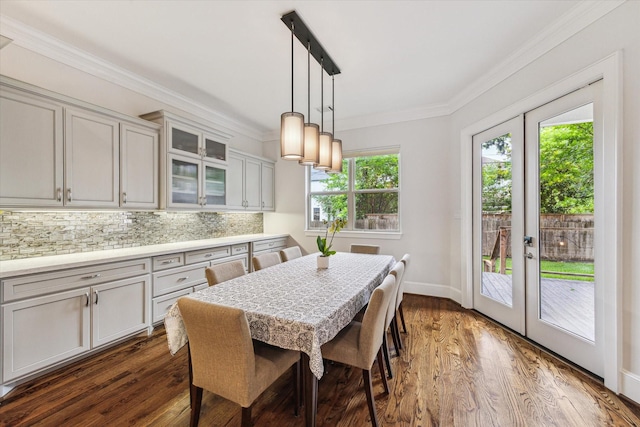 5204 Chestnut St, Bellaire, TX 77401 - dining room featuring french doors, crown molding, dark wood-style flooring, and baseboards