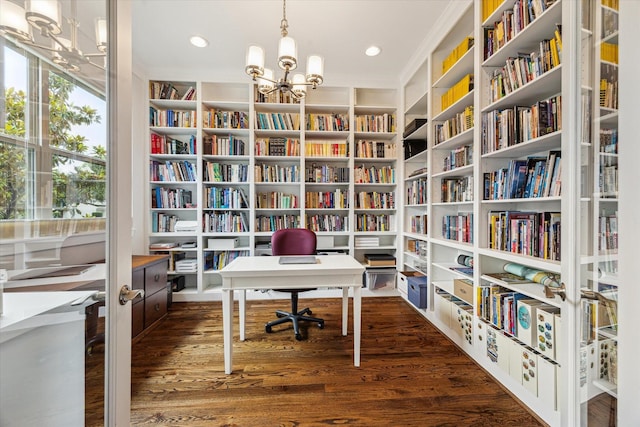 5204 Chestnut St, Bellaire, TX 77401 - home office featuring bookshelves, a chandelier, dark wood-style floors, and built in features