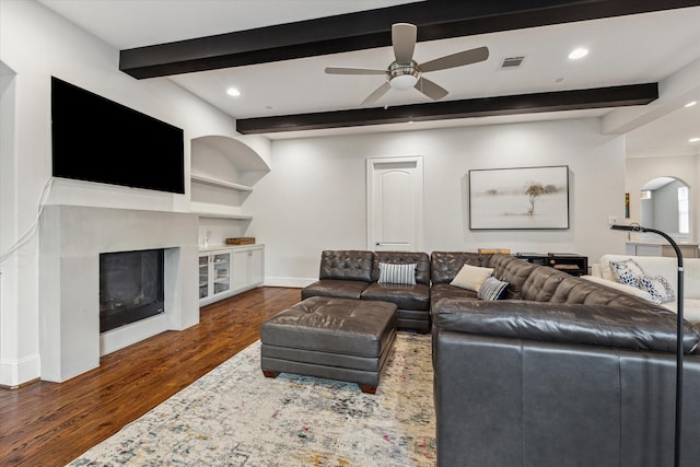 5204 Chestnut St, Bellaire, TX 77401 - living room featuring beamed ceiling, dark wood-style floors, a glass covered fireplace, recessed lighting, and a ceiling fan