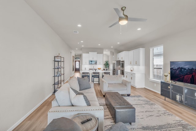 28403 Hannahs Harbor Ln, Katy, TX 77494 - living area with light wood finished floors, a ceiling fan, baseboards, and recessed lighting