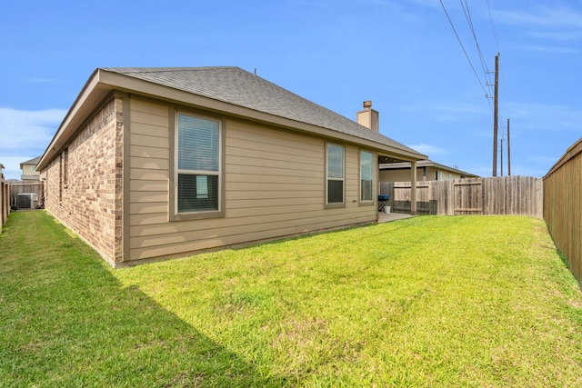 28403 Hannahs Harbor Ln, Katy, TX 77494 - rear view of house with brick siding, a chimney, central AC unit, and roof with shingles