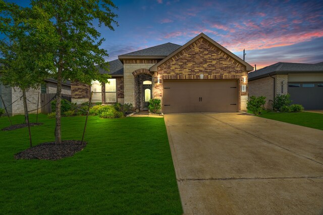 28403 Hannahs Harbor Ln, Katy, TX 77494 - french provincial home with brick siding, driveway, a garage, a front lawn, and roof with shingles