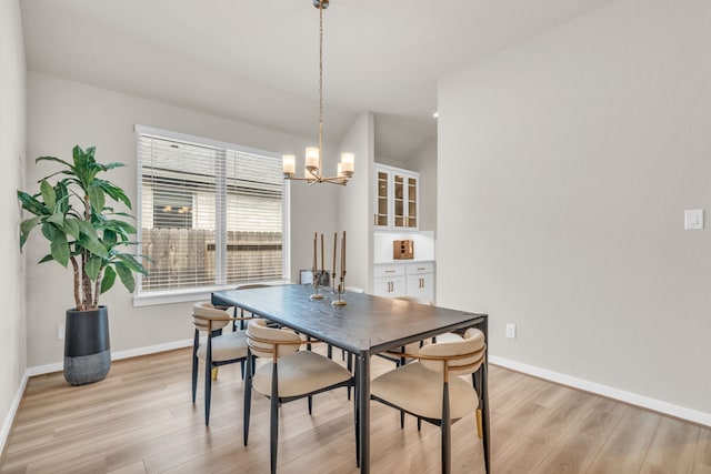 28403 Hannahs Harbor Ln, Katy, TX 77494 - dining room featuring a chandelier, light wood-style flooring, and baseboards