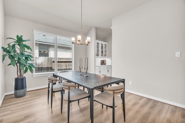 28403 Hannahs Harbor Ln, Katy, TX 77494 - dining area with light wood finished floors, a chandelier, and baseboards