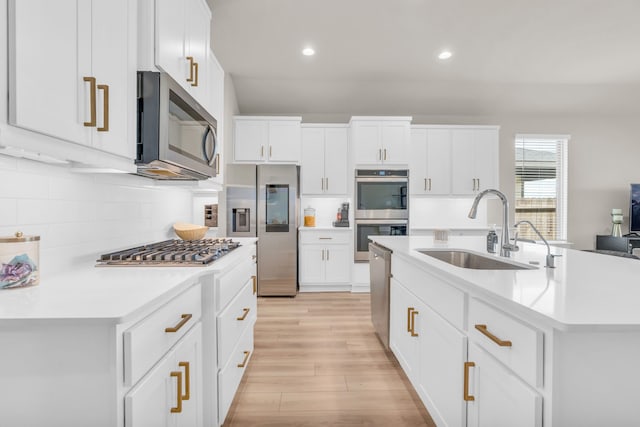 28403 Hannahs Harbor Ln, Katy, TX 77494 - kitchen with stainless steel appliances, a sink, recessed lighting, decorative backsplash, and light countertops