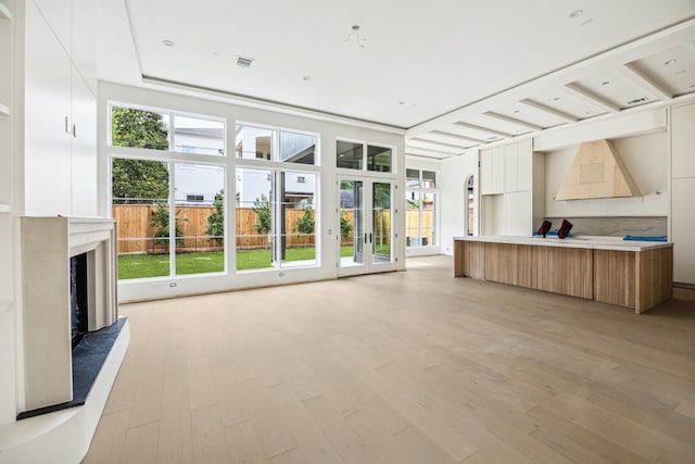 1656 Banks St, Houston, TX 77006 - living room featuring a fireplace, light wood-style flooring, and french doors