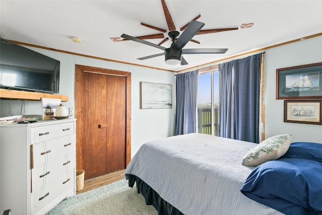 334 Bay Ave, Surfside Beach, TX 77541 - bedroom with ornamental molding, light wood-style floors, and ceiling fan