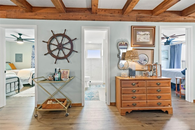 334 Bay Ave, Surfside Beach, TX 77541 - corridor with beam ceiling, wood finished floors, electric panel, and baseboards