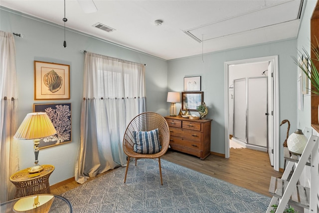 334 Bay Ave, Surfside Beach, TX 77541 - living area with attic access, wood finished floors, and baseboards