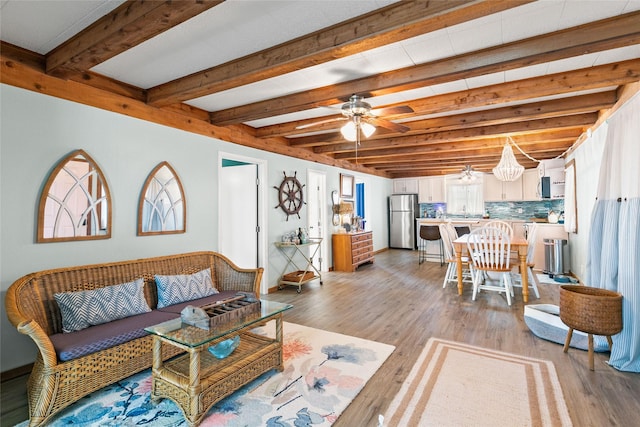334 Bay Ave, Surfside Beach, TX 77541 - living room with light wood-style floors, beam ceiling, and ceiling fan