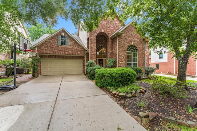 14 Brywood Pl, The Woodlands, TX 77382 - traditional-style house featuring driveway, brick siding, and a garage
