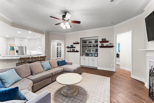 14 Brywood Pl, The Woodlands, TX 77382 - living area with a ceiling fan, washer / dryer, wood finished floors, recessed lighting, and baseboards