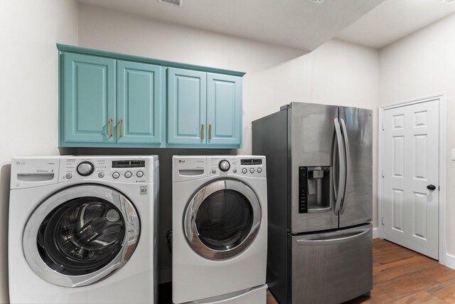 14 Brywood Pl, The Woodlands, TX 77382 - laundry room featuring washer and clothes dryer, cabinet space, and dark wood-style flooring