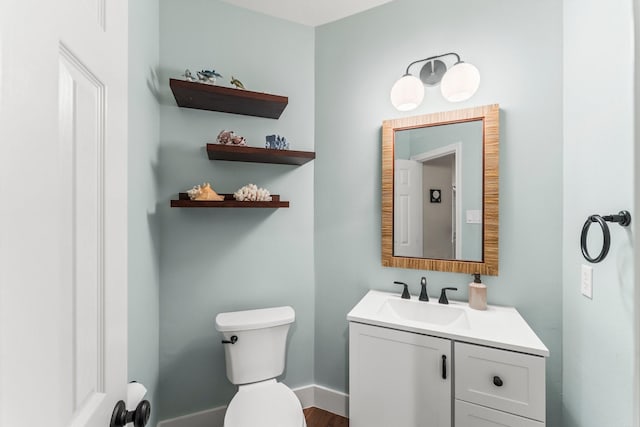 14 Brywood Pl, The Woodlands, TX 77382 - half bathroom with vanity, toilet, baseboards, and wood finished floors