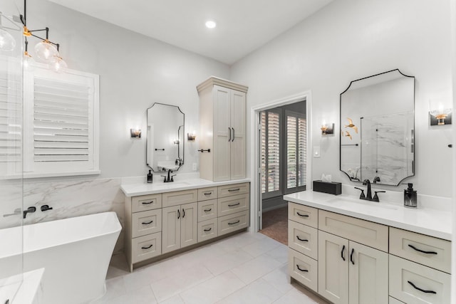 14 Brywood Pl, The Woodlands, TX 77382 - bathroom with a marble finish shower, a freestanding tub, two vanities, tile patterned floors, and tile walls