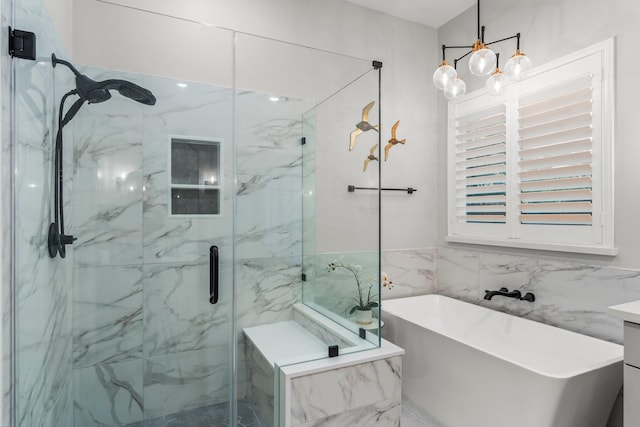 14 Brywood Pl, The Woodlands, TX 77382 - full bath with tile walls, a marble finish shower, a soaking tub, and a chandelier