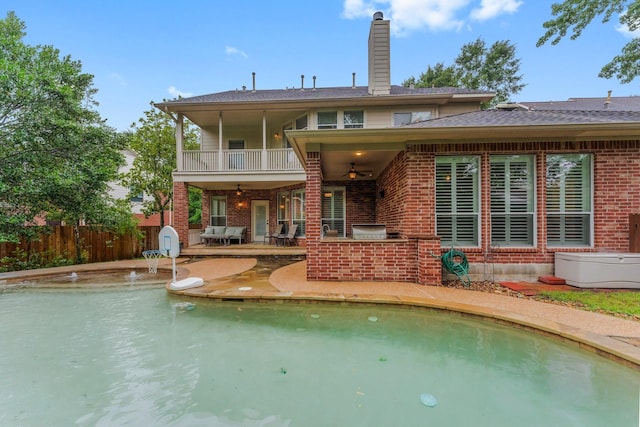 14 Brywood Pl, The Woodlands, TX 77382 - rear view of property with brick siding, ceiling fan, exterior kitchen, a patio, and a balcony