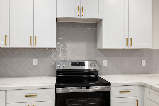 509 W Sixth St, Brenham, TX 77833 - kitchen featuring electric stove, white cabinetry, and tasteful backsplash